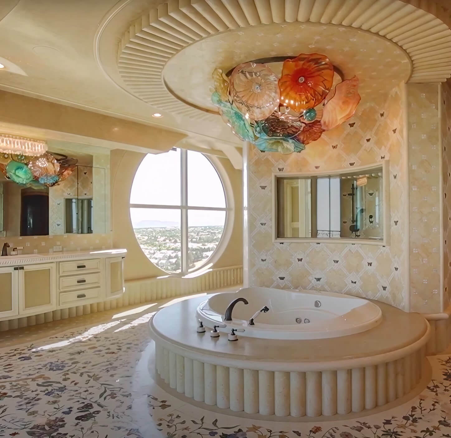 A luxurious bathroom featuring a spacious circular tub and an expansive mirror, exuding elegance and tranquility.