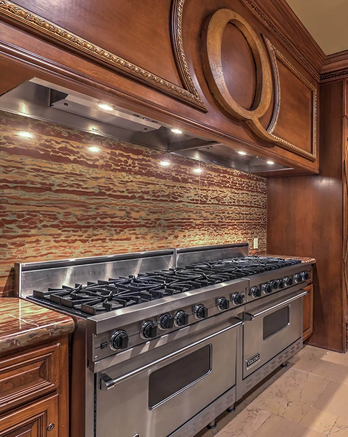 A modern kitchen featuring a stove and oven, showcasing a clean and organized cooking space.