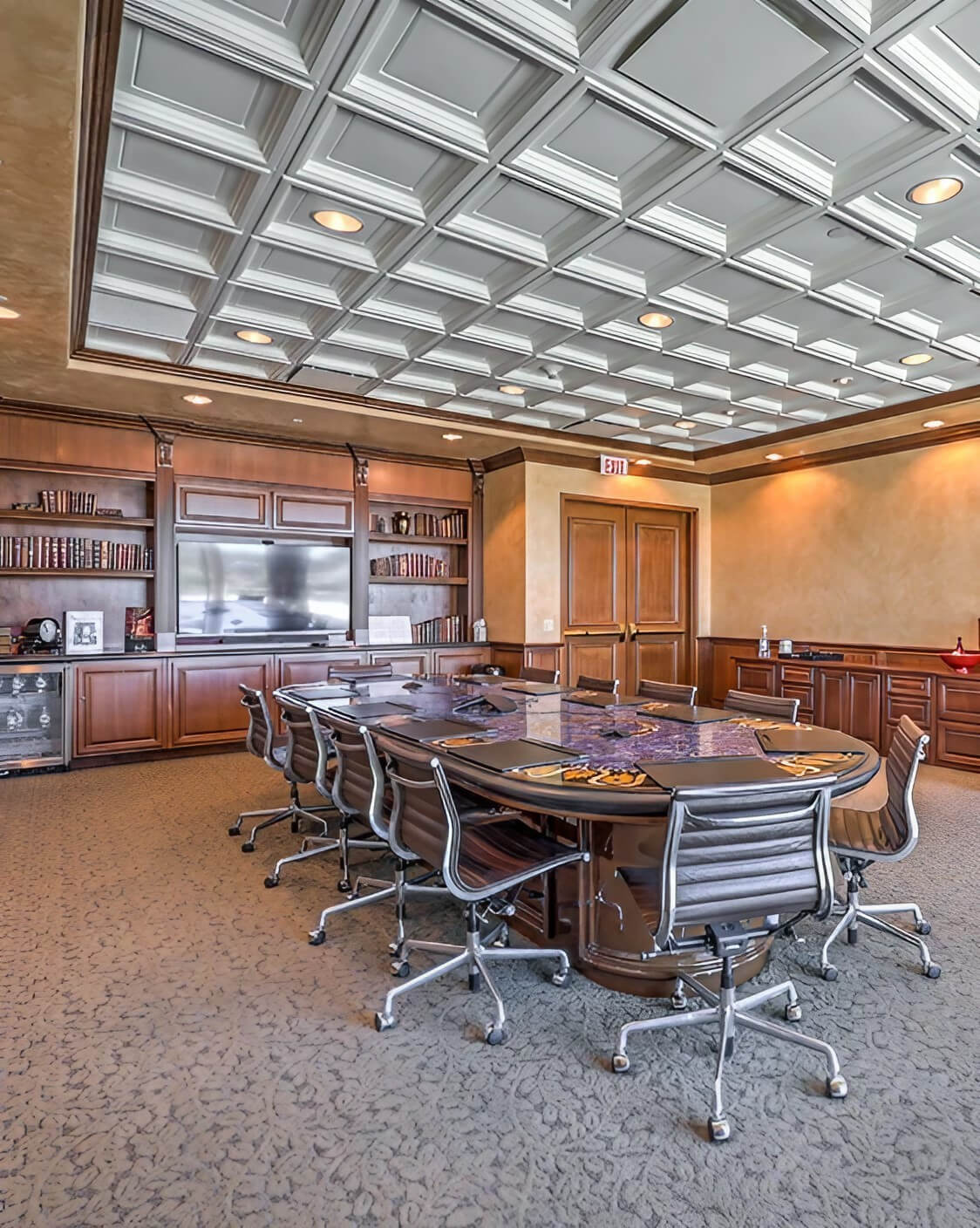 A spacious conference room featuring a large table surrounded by several chairs, ready for meetings and discussions.