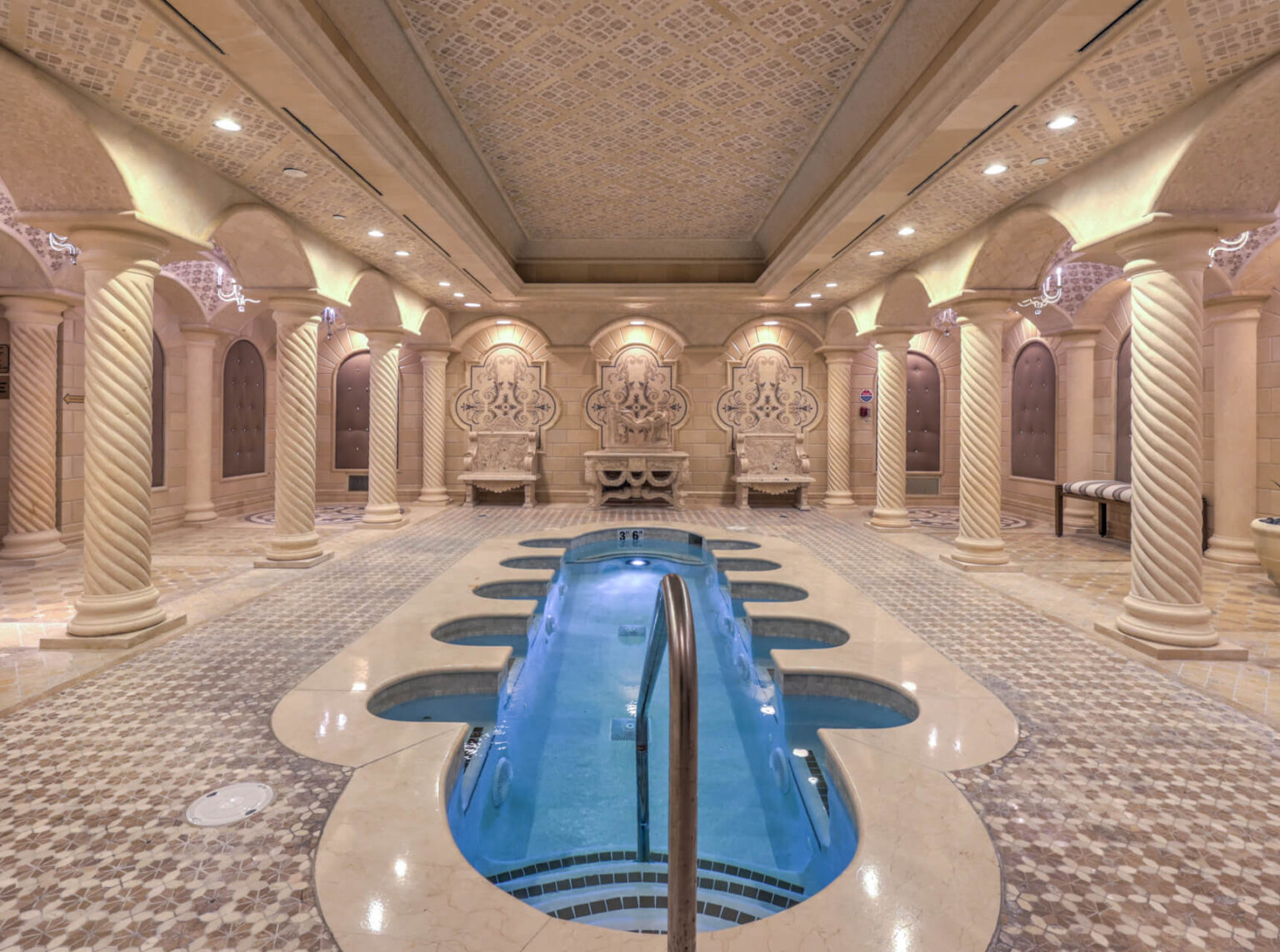 A stunning indoor pool surrounded by elegant architecture and serene ambiance.